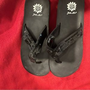 Yellow box black flip flops